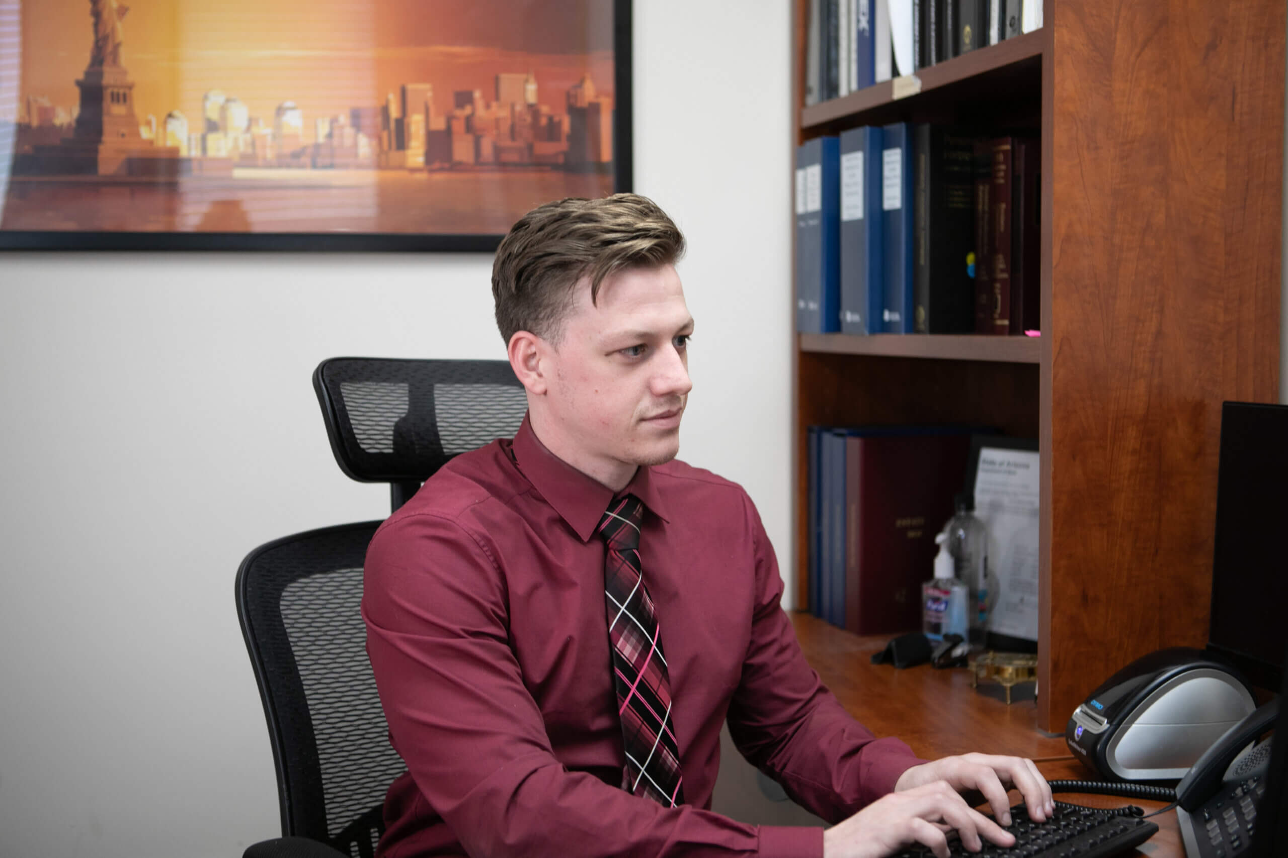A male paralegal working on his computer reviewing information pertaining to Arizona Family Law