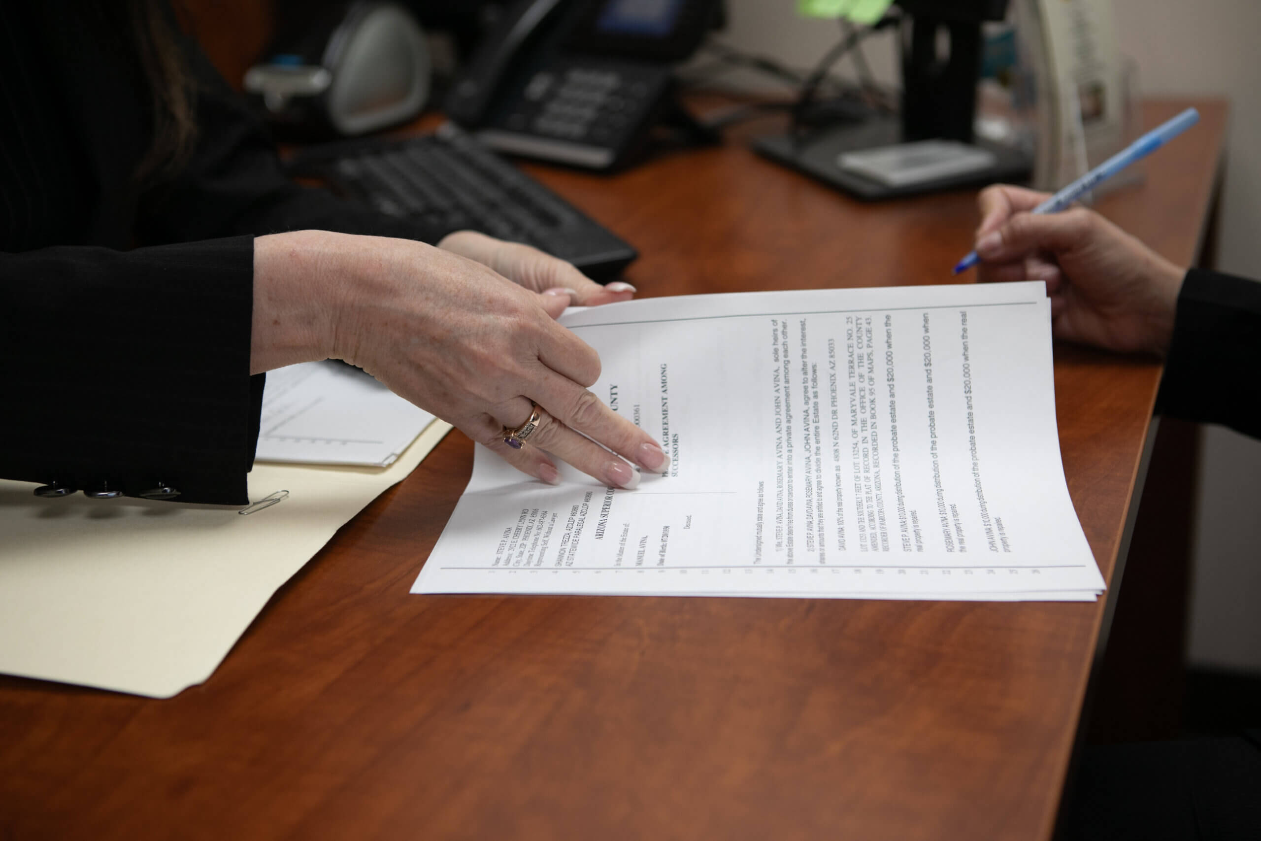A paralegal and a client reviewing legal documents
